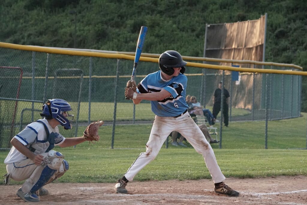 Young baseball players in action during a sunny outdoor game.